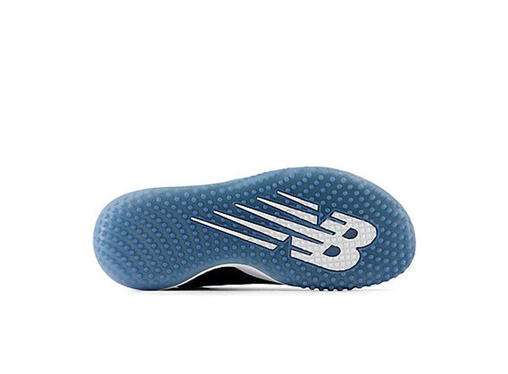 Women's turf shoe outsole in blue, textured traction with large New Balance logo
