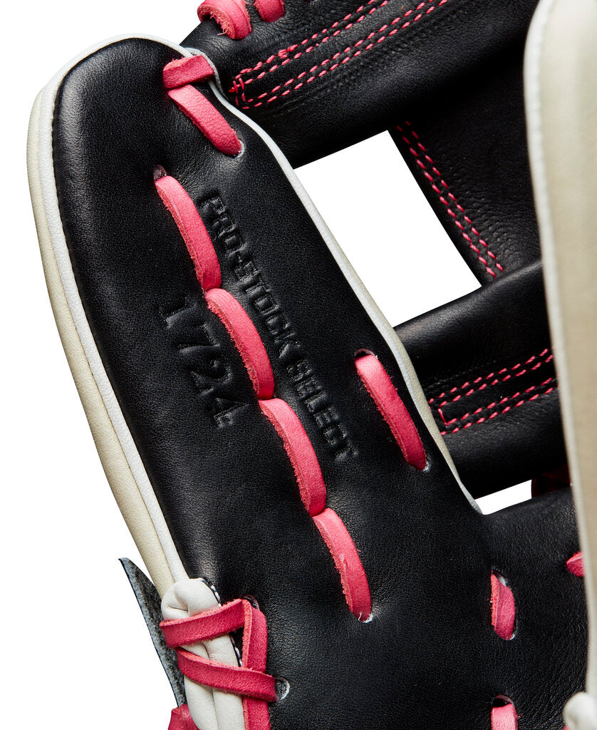 Wilson A2K baseball glove close-up, black leather with pink stitching and lace details.