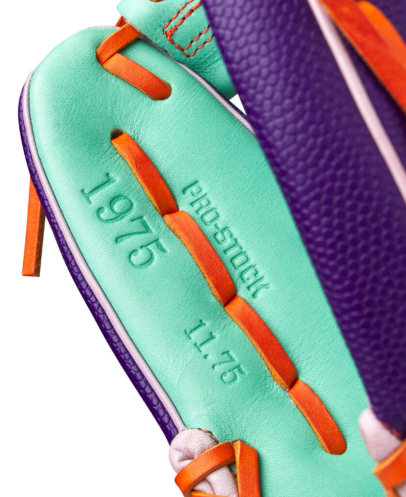 Baseball glove close-up of seafoam palm leather with orange lace and embossed lettering