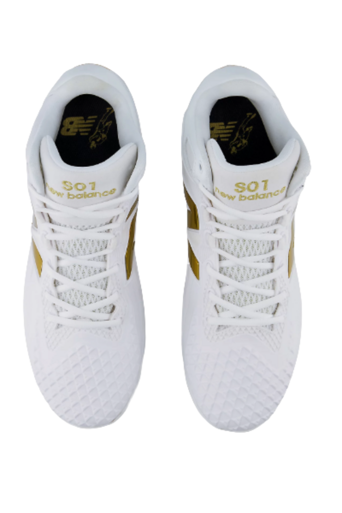 Pair of white baseball cleats with white laces and gold heel branding