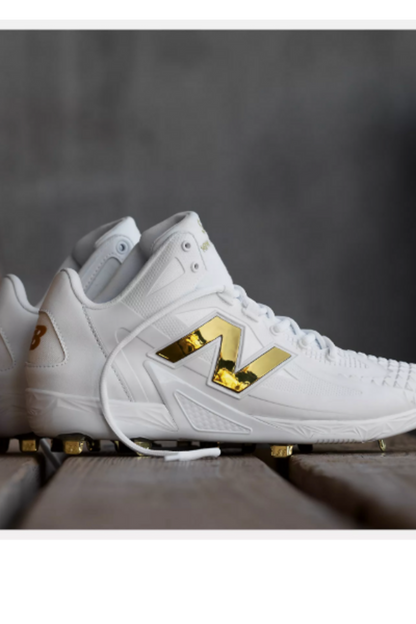 White baseball cleat side view with gold logo and lace-up closure