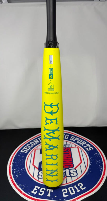 Yellow baseball bat handle area with blue label and teal graphics on barrel, upright