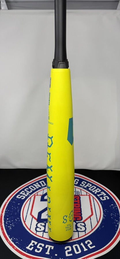 Yellow baseball bat standing upright with black handle; barrel graphics and grip end visible