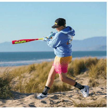 Pink baseball bat with neon green grip and colorful printed barrel graphics