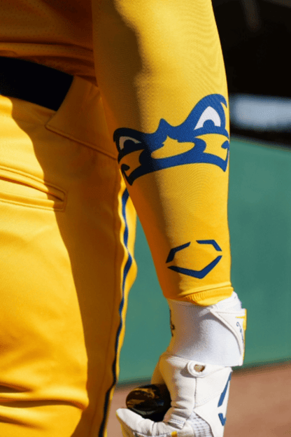 Yellow compression arm sleeve with blue graphic, worn on arm