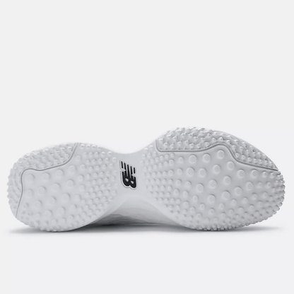 White turf shoe outsole with round studs and black New Balance logo
