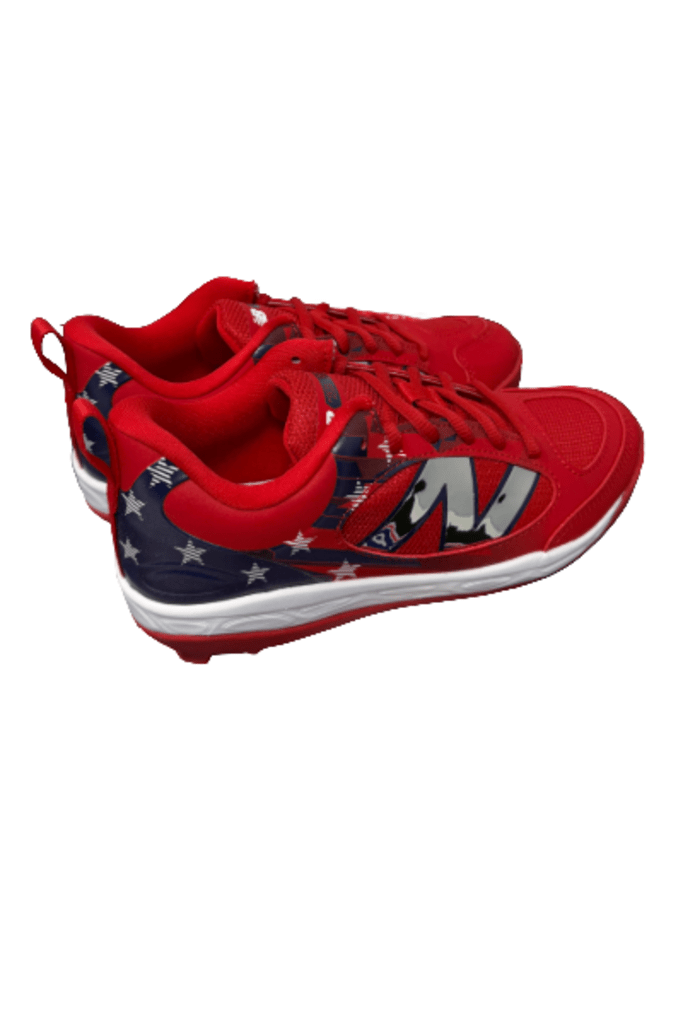 Youth molded cleats with red upper, navy graphic stripe, and white outsole