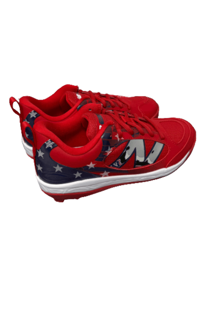 Youth molded cleats with red upper, navy graphic stripe, and white outsole
