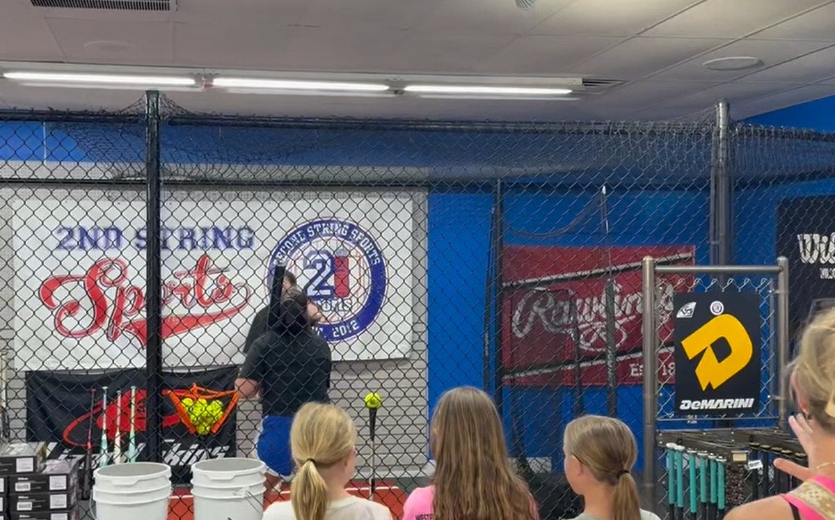 Sam Hensley Practicing her swing in our demo cage for onlookers