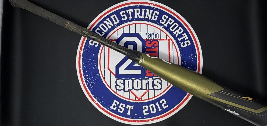 Used baseball bat with dark olive barrel and black grip, side view