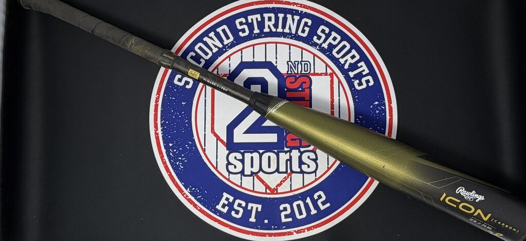 Used baseball bat with dark olive barrel, black grip, and handle-side markings