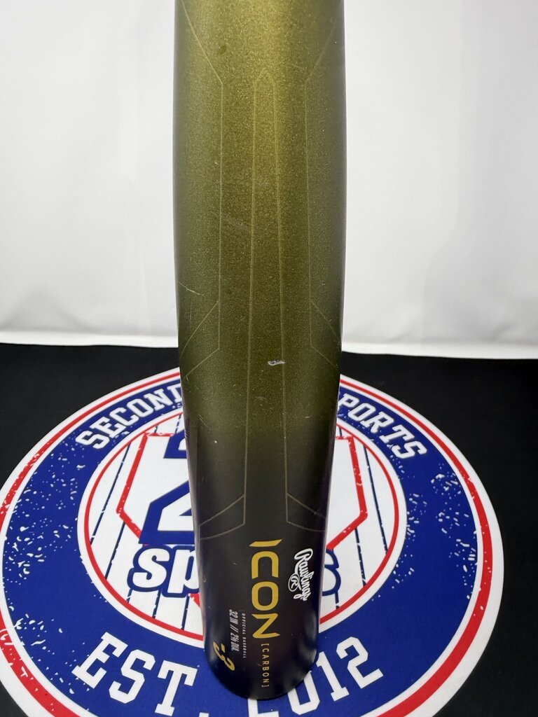 Used baseball bat grip with white 'ICON' text on olive barrel