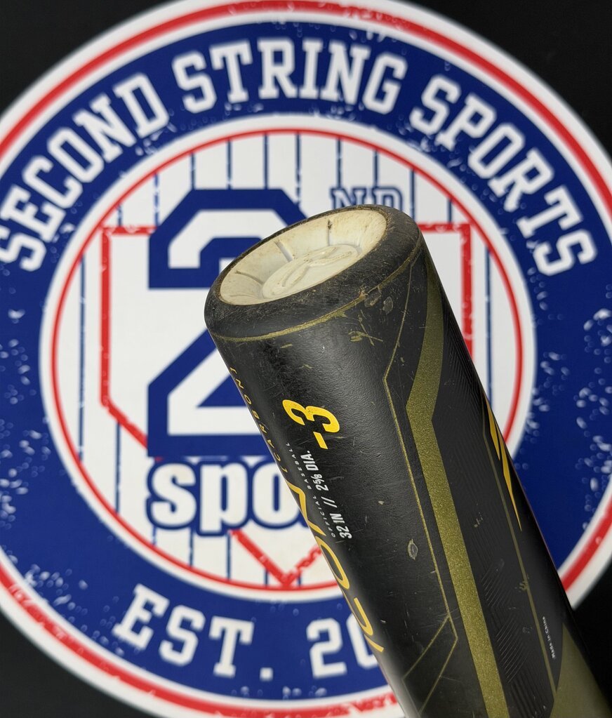 Used baseball bat showing end cap and black grip on a dark olive barrel