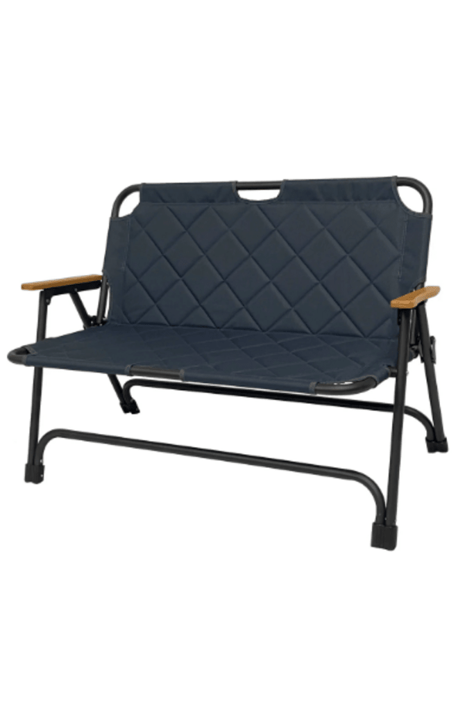 Folding portable bench with quilted dark fabric back and arm supports