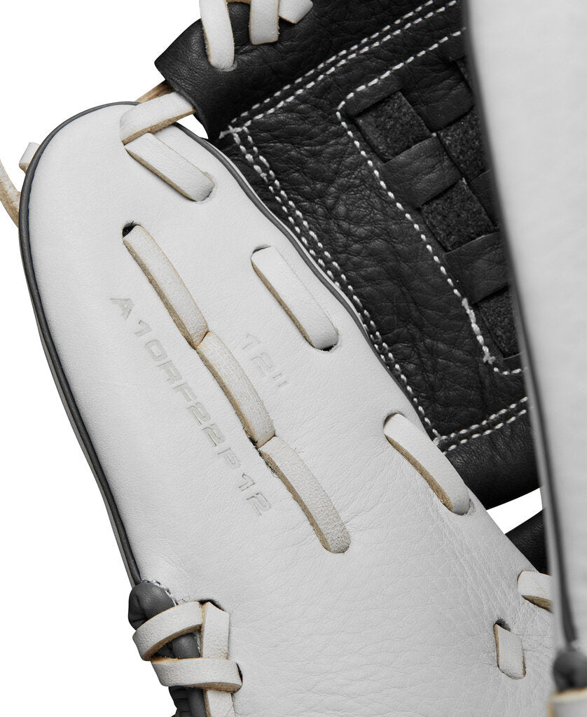 Fastpitch softball glove close-up, white palm panels with black leather and stitched laces