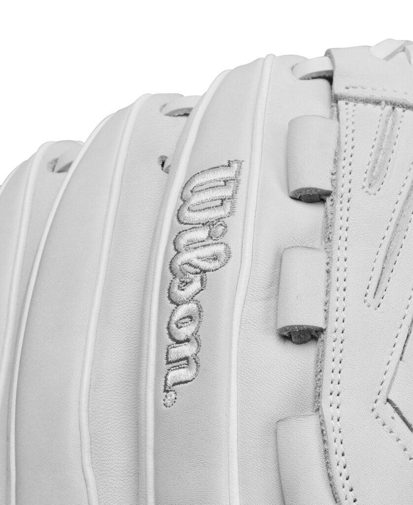 White fastpitch glove close-up of raised Wilson script on back panel