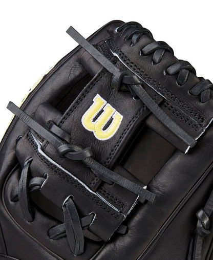 Black baseball glove close-up of the web with yellow Wilson “W” and thick laces