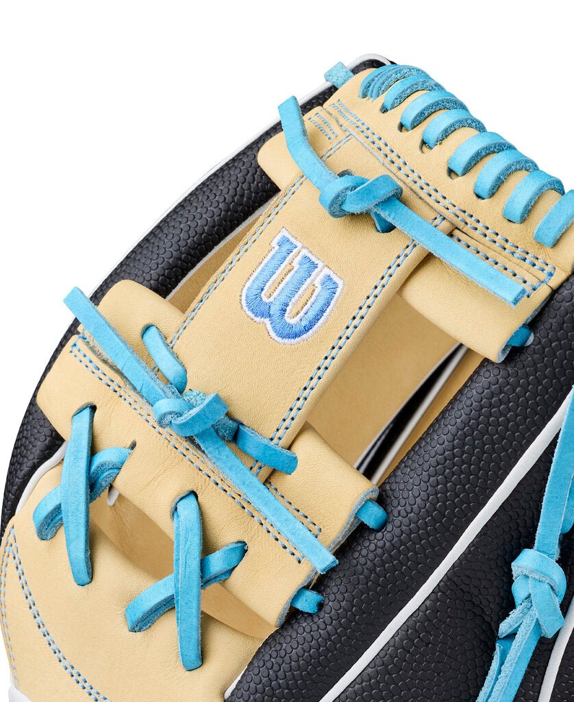 Fastpitch infield softball glove close-up of tan wrist strap and blue top lacing.