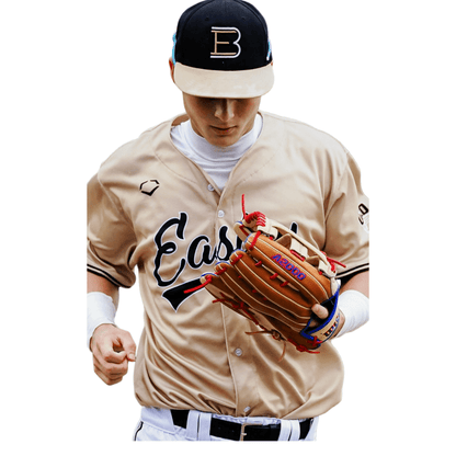 Tan baseball glove worn by player over cream jersey, red-and-blue lacing details