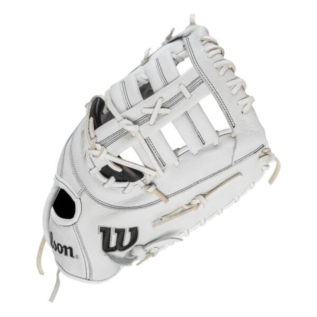 Wilson first base mitt in white with black pocket, laced for fastpitch catching