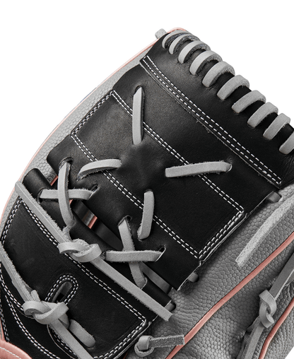 Fastpitch softball glove top view with black web, grey laces, and pink piping