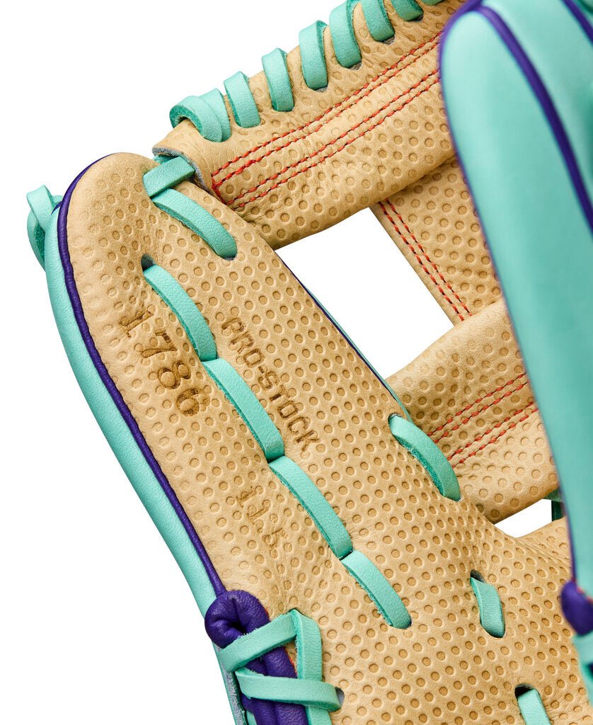 Baseball glove web close-up in blonde with seafoam lacing and purple border